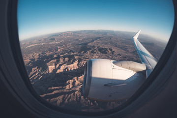 Mountainous window seat view from airplane