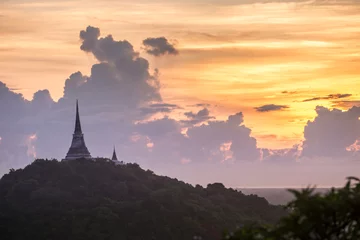 Fotobehang silhouette of Buddha pagoda with sunset sky © aee_werawan