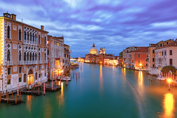 Grand canal and The Basilica of St Mary of Health or Basilica di Santa Maria della Salute at night in Venice, Italy