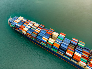 Cargo container ship carrying container import and export  goods running around container yard port...