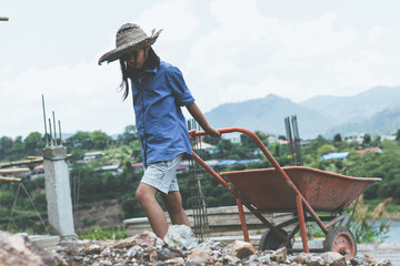 Children working at construction site for world day against children labour concept: