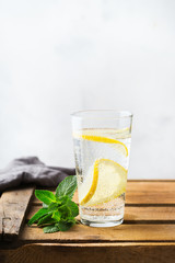 Glass of fresh cool lemon infused water detox drink