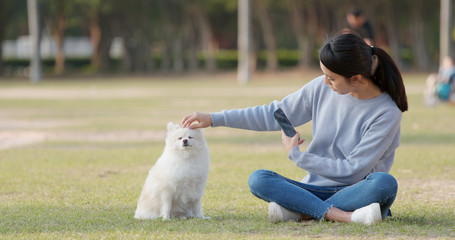 Woman taking photo with her dog