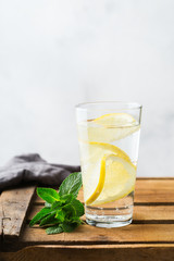 Glass of fresh cool lemon infused water detox drink