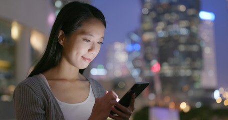 Woman use of smart phone for online at outdoor in the evening