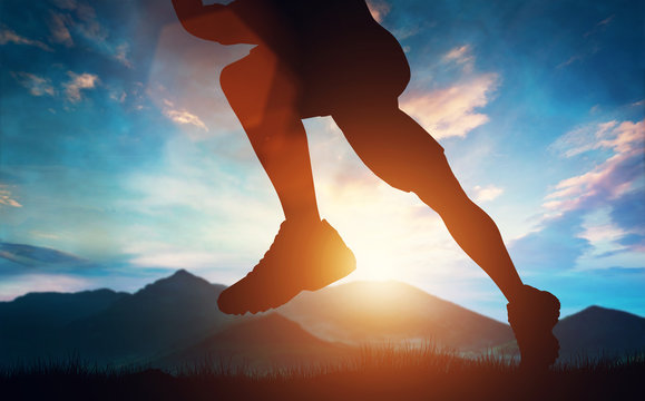 Man running in the mountains at the sunset.