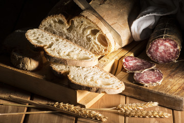 snack with rustic bread and salami on the wooden table