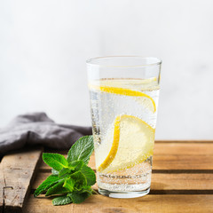 Glass of fresh cool lemon infused water detox drink