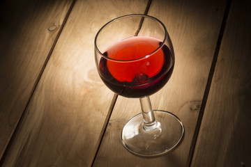 glass of red wine on the wooden table