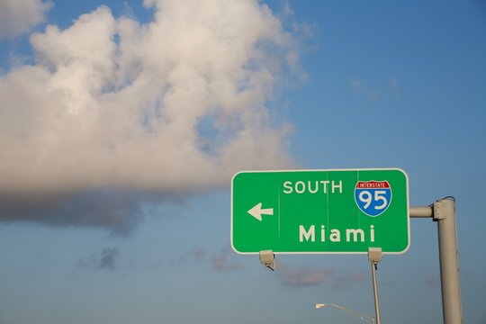 I-95 South Miami Sign with Arrow against Partly Cloudy Blue Sky