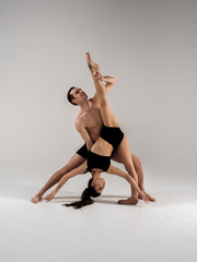 Modern ballet dancer couple in black form performing art element with empty copy space background, izolated