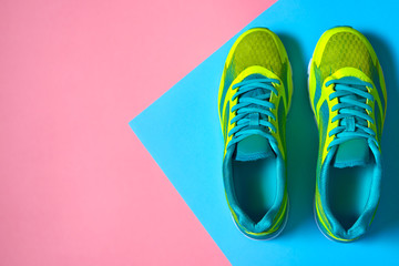 Pair of sport shoes on colorful background. New sneakers on pink and blue pastel background, copy...