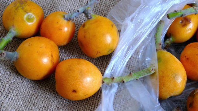 mature loquat, spring fruity, Japanese loquat medlar on wooden floor
