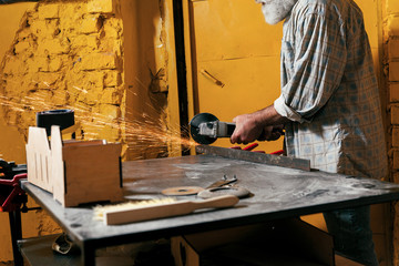 Locksmith cuts metal in the workshop