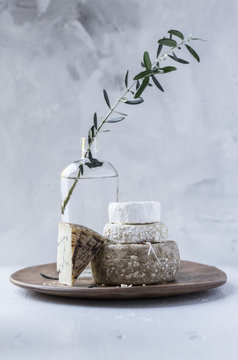 Aged cheeses stacked on wood platter