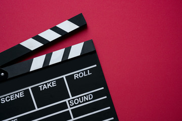 movie clapper on red background ; film, cinema and video photography concept