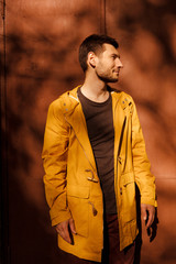 A handsome and fashionable guy in stylish clothes on the street