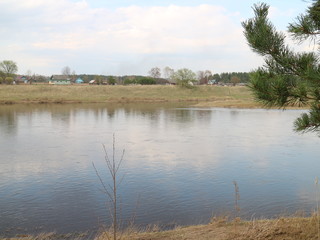 the banks of the spring river in the evening at sunset