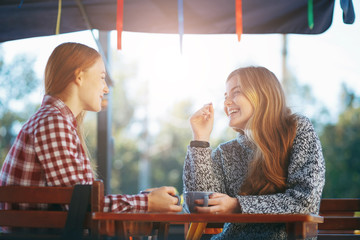 Smiling young women drinking coffee 