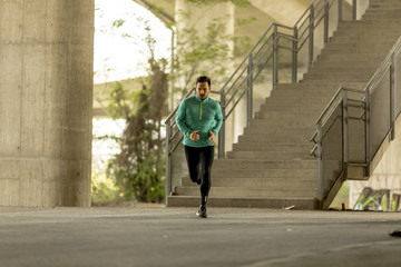 Young man running in urban enviroment