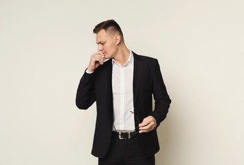 Pensive businessman with glasses in hand