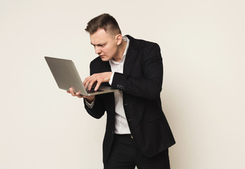 Disappointed caucasian businessman using laptop