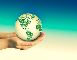 Ecological concept of the environment with the cultivation of trees on the ground in the hands. Planet Earth. Physical globe of the earth. Elements of this image furnished by NASA. 3D illustration