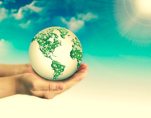Ecological concept of the environment with the cultivation of trees on the ground in the hands. Planet Earth. Physical globe of the earth. Elements of this image furnished by NASA. 3D illustration