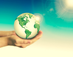 Ecological concept of the environment with the cultivation of trees on the ground in the hands. Planet Earth. Physical globe of the earth. Elements of this image furnished by NASA. 3D illustration