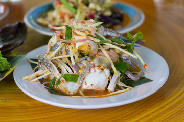 SOM-TAM, Thai delicious raw papaya salad with unique taste hot and spicy, this dish with tomato and crab. Papaya salad with red chili.