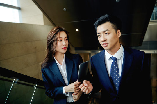 Business people talking in the elevator