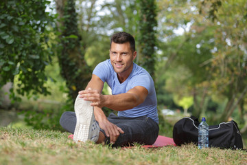 warming up for jogging in public park