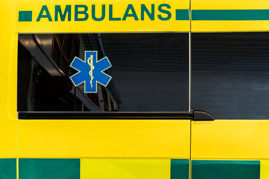 CLose up side view of a yellow and green Swedish ambulance vehicle.
