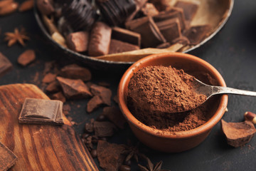 Cocoa bowl and crushed chocolate pieces on gray background