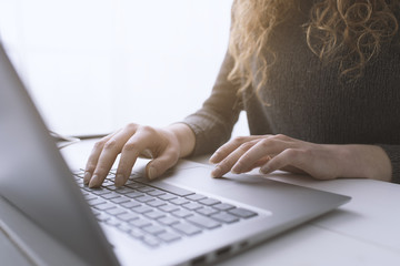 Woman sitting at desk and connecting with her laptop