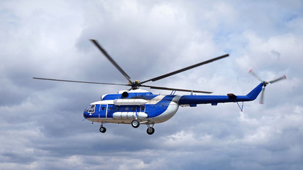 White blue helicopter on the sky background. Model MI-8