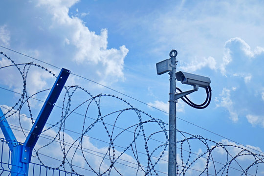 Fence, barbed wire and video camera.