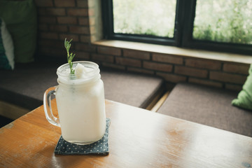coconut water frappe with rosemary leaf on restaurant table