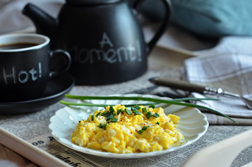Scrambled eggs and tea served on a bed tray