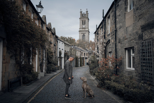 Man and a dog in beautiful street