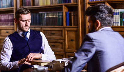 Intelligent elite and education concept. Men with antique bookshelves
