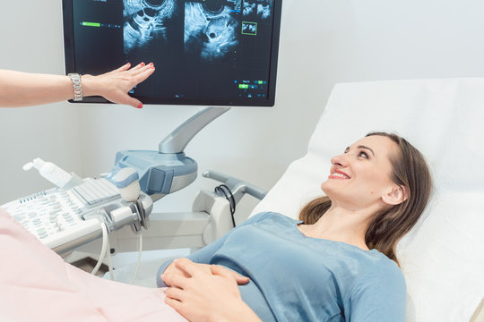 Woman at the gynecologist having ultrasonic examination as pregnancy test