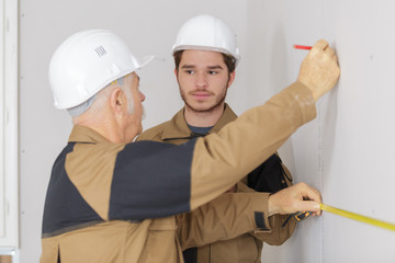 builders drawing the line on the wall