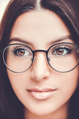 Beautiful young woman wearing glasses. Close up shot.