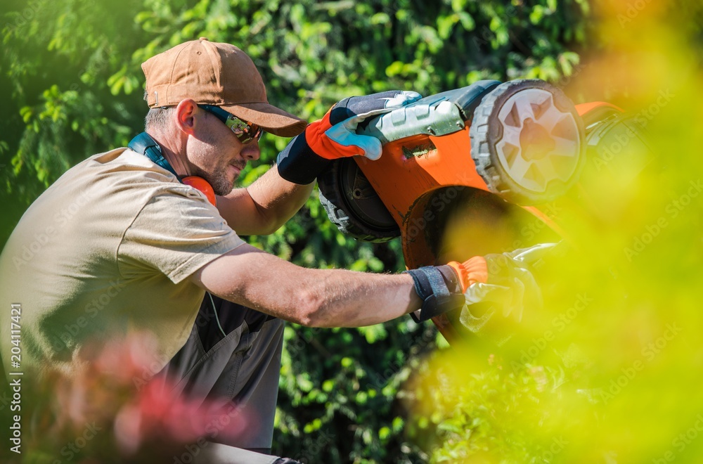 Wall mural Men Fixing Lawn Mower