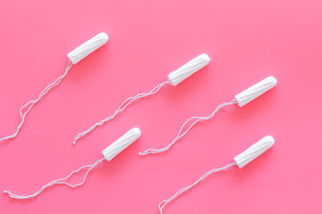 Woman hygiene protection. Cotton tampons like sperms on pink background top view pattern