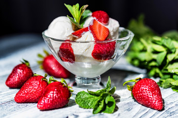 Strawberry ice cream in bowl and strawberries
