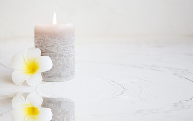 Spa tranquil setting with frangipani and candle