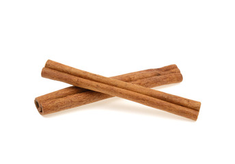 two cinnamon sticks on a white background