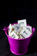 letter blocks in a bucket